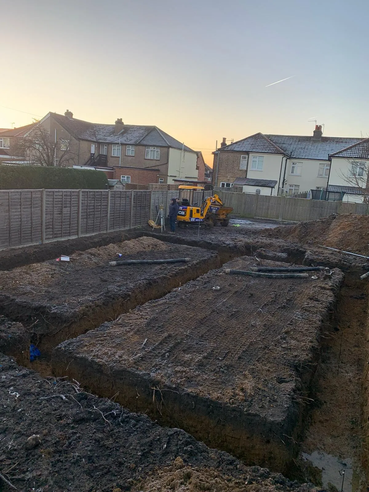 A construction site with a bulldozer in the background.