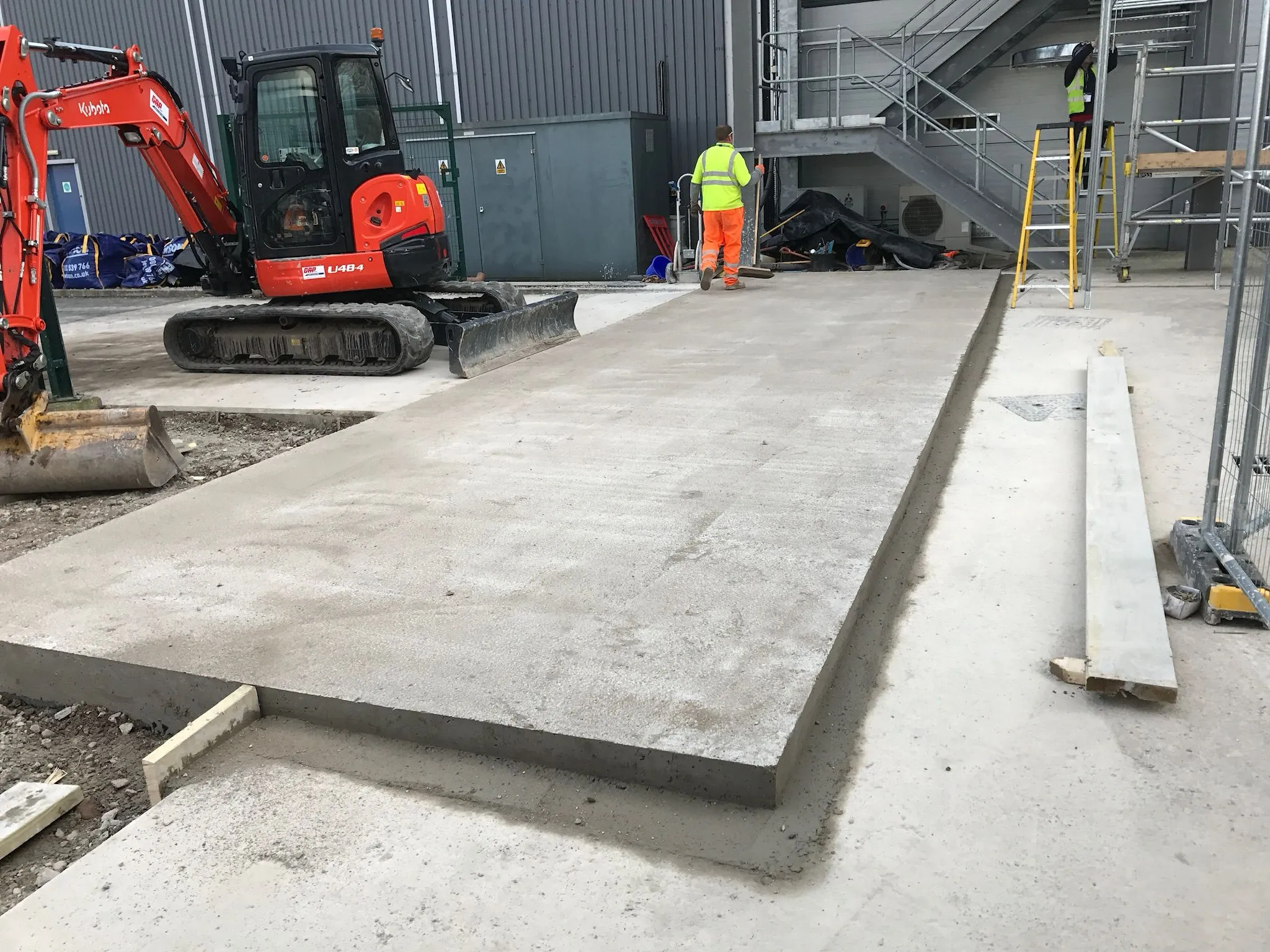 A construction site with construction equipment and workers.