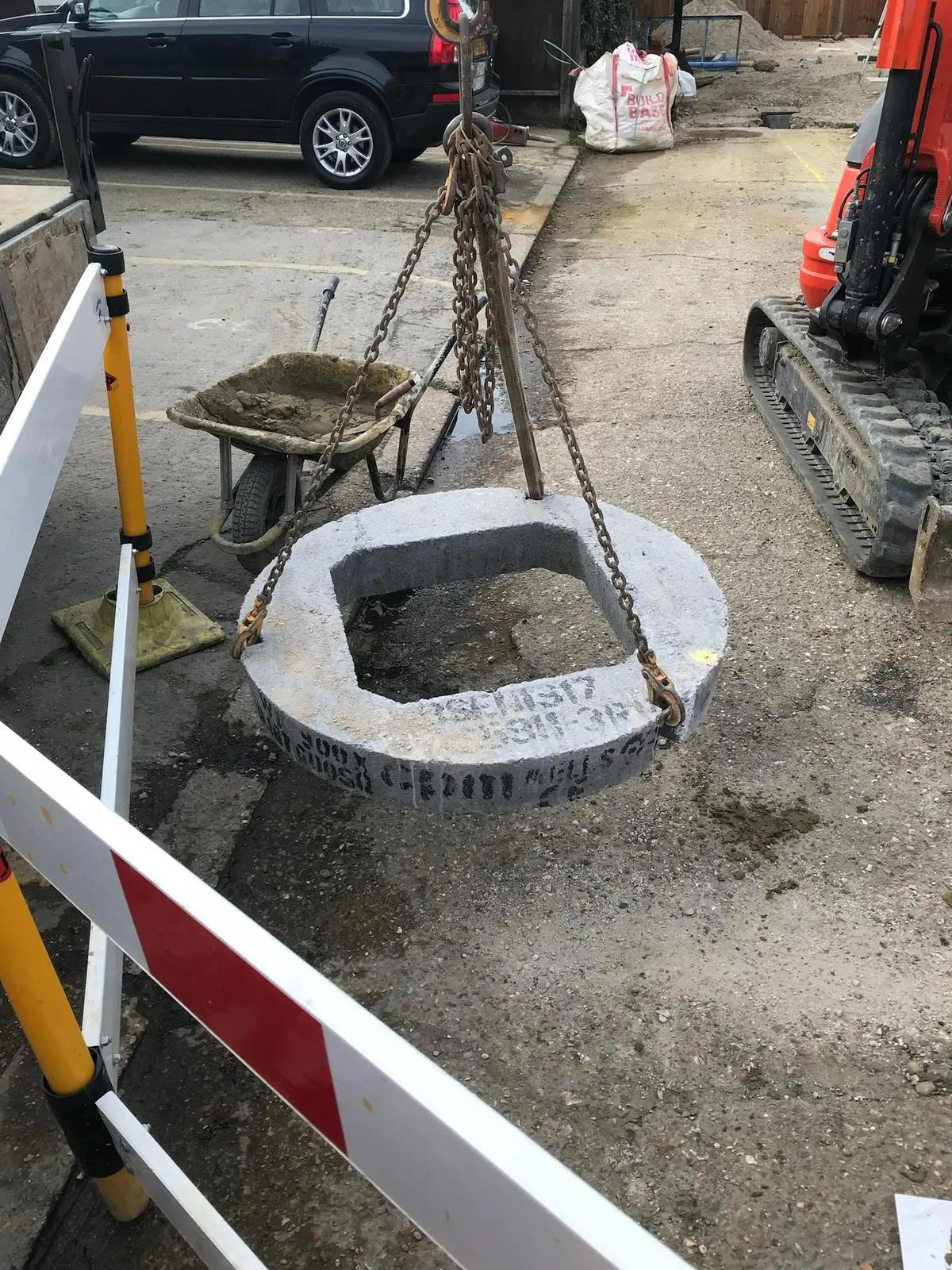 A tire swing sitting in the middle of a parking lot.
