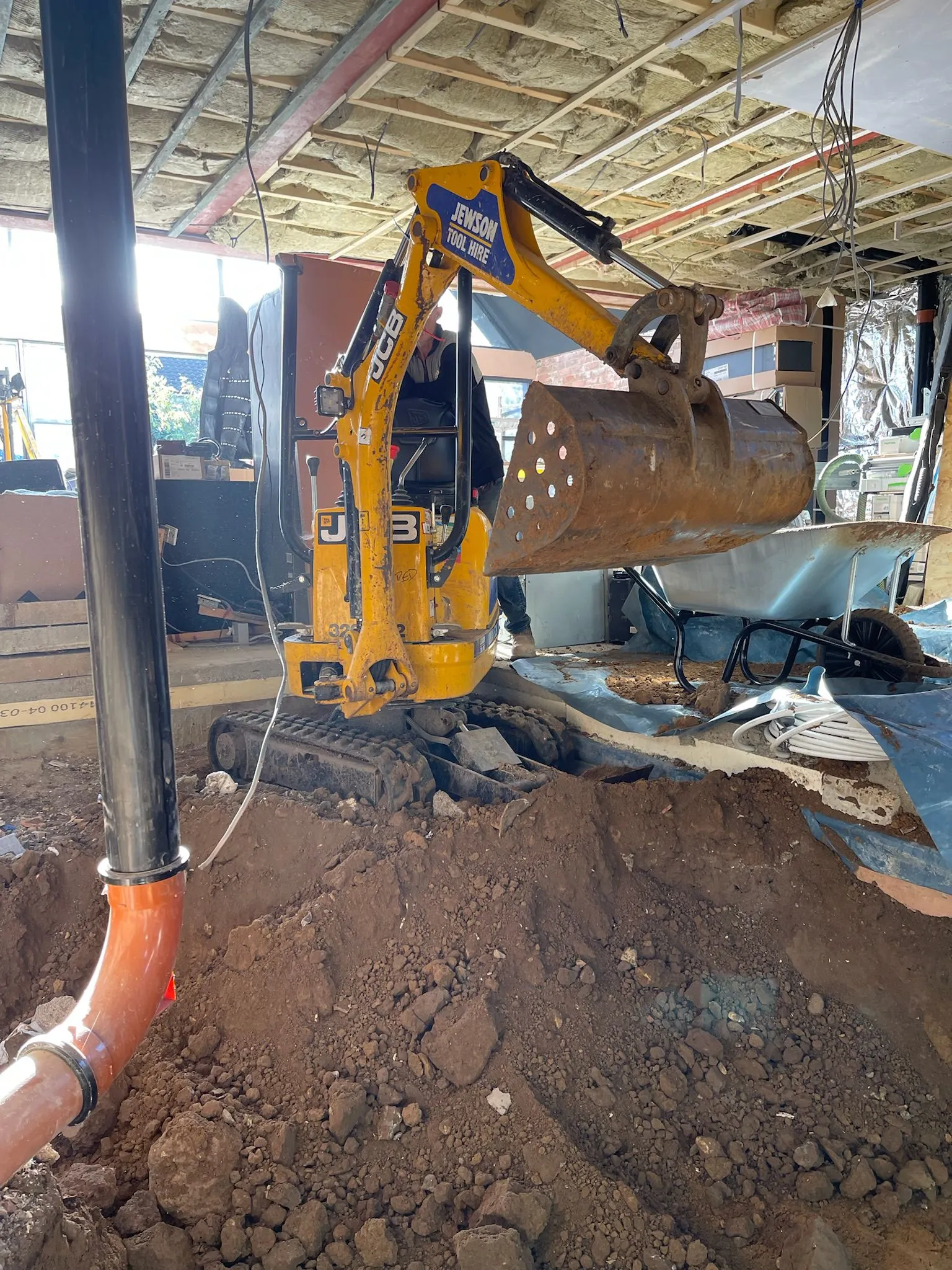 A bulldozer digging through a pile of dirt.